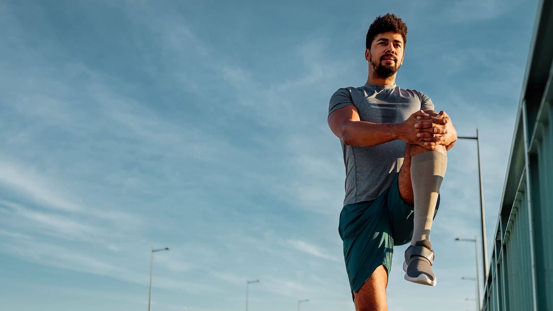 Man performing knee raise stretches